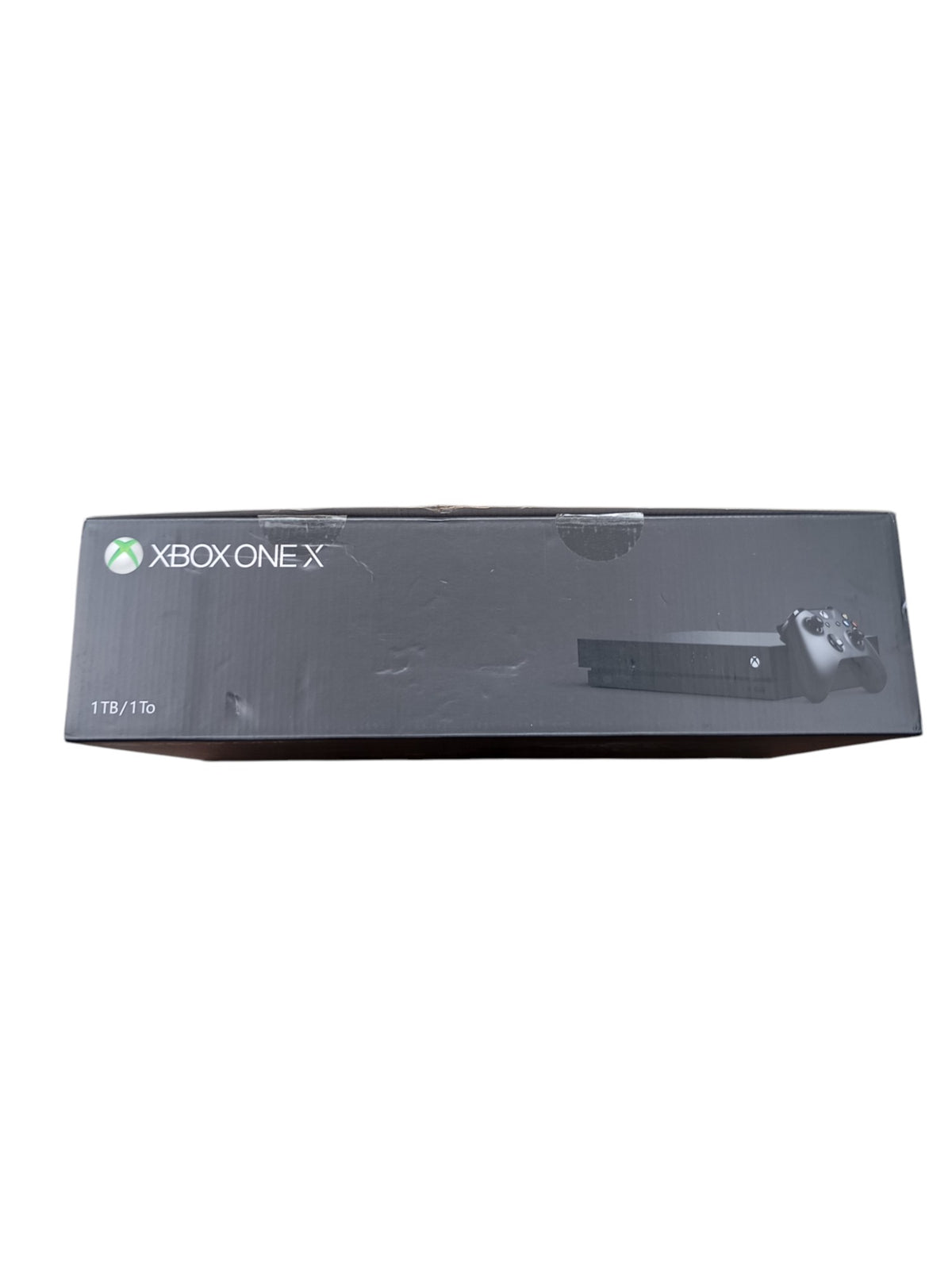 Console Xbox One X en boîte